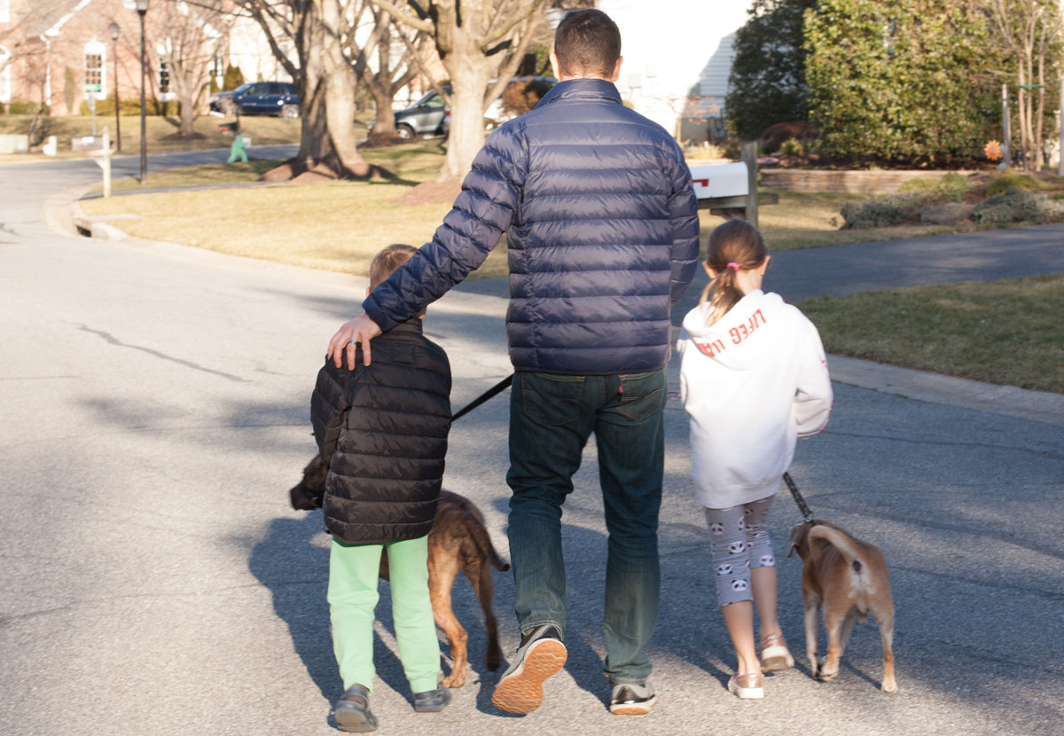 Ravas takes a walk with his children and their dogs.