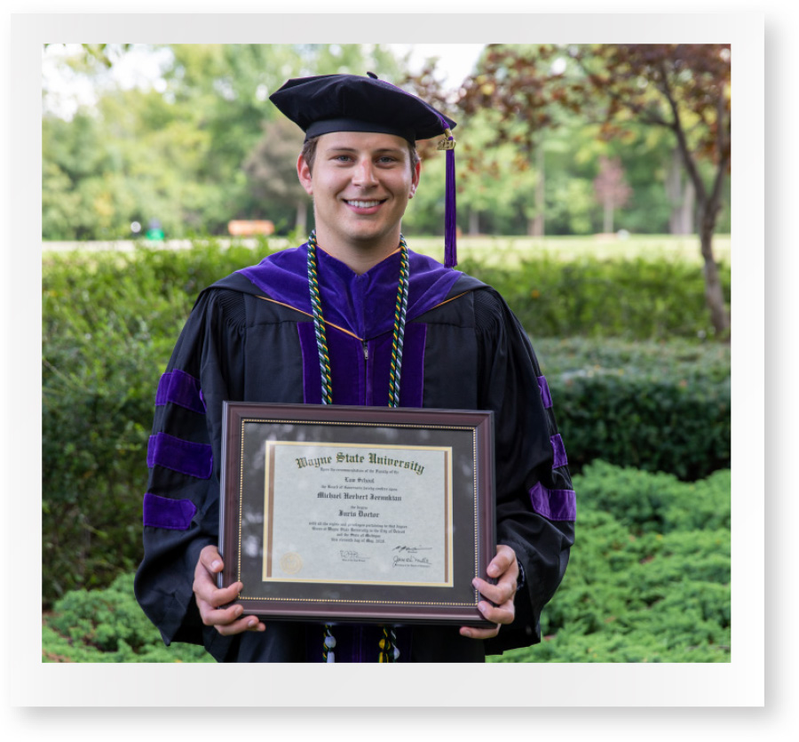 polaroid of male student holding bachelor's degree in hands