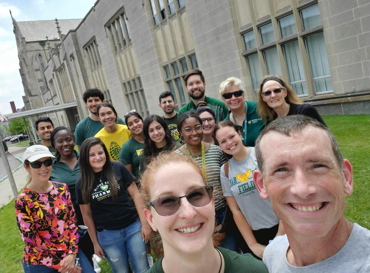 Wayne Law students Erin Deschamps and Matt Antoniou take a group selfie with members of the Community Homeless Interprofessional Program