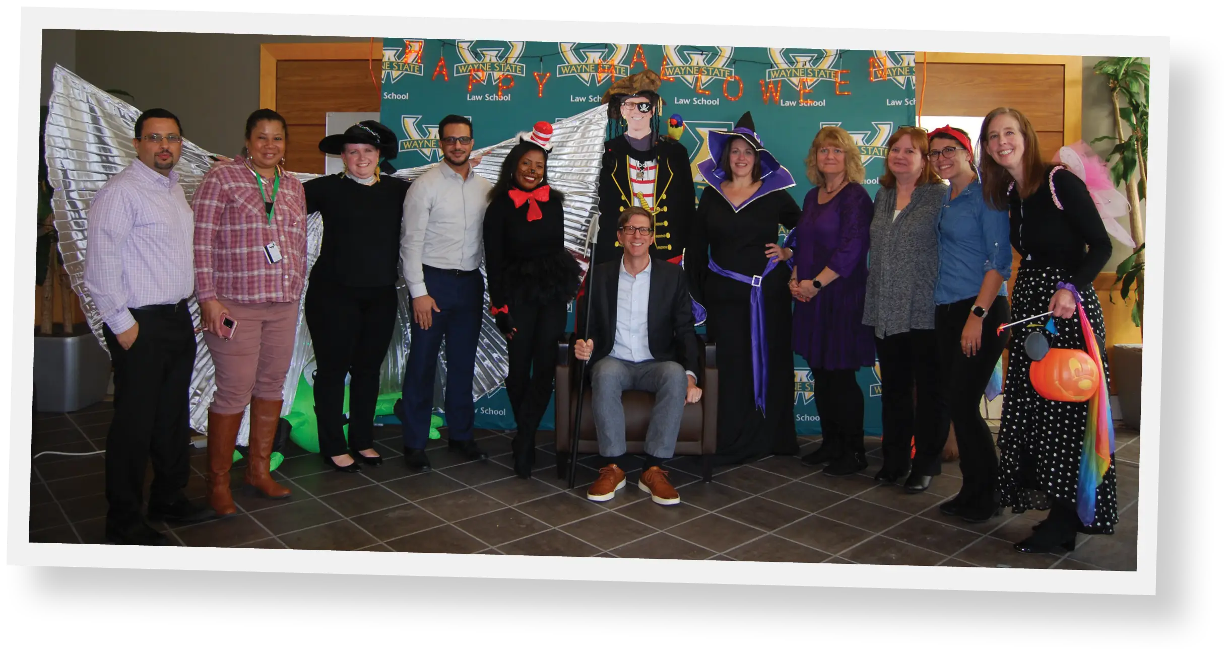 Group of faculty posing for picture during halloween party
