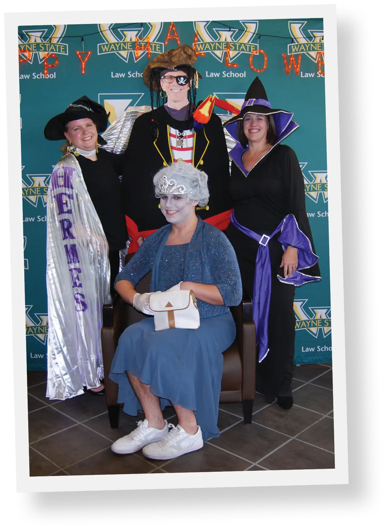 Three faculty members posing for picture during halloween party dressed in halloween costumes