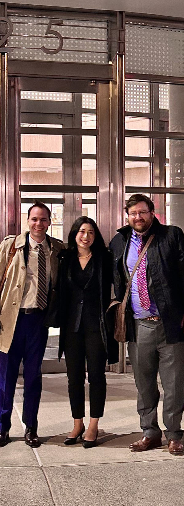 Calder Burgam, Amanda Navarre and Brian Sarnacki in front of building