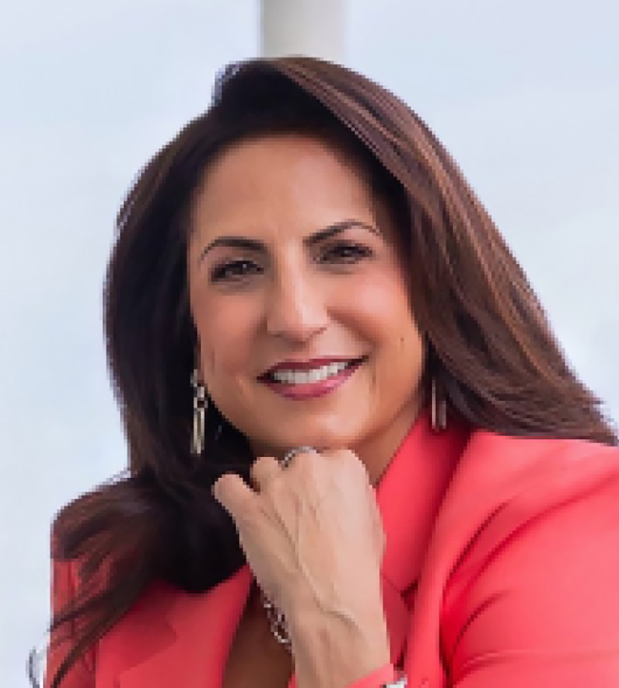Headshot of Lisa J. Hamameh smiling with her hand resting underneath her chin